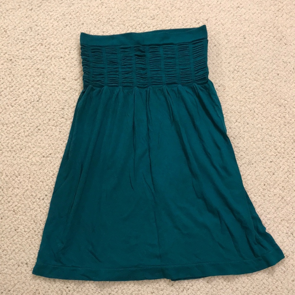 Turquoise sleeveless top.